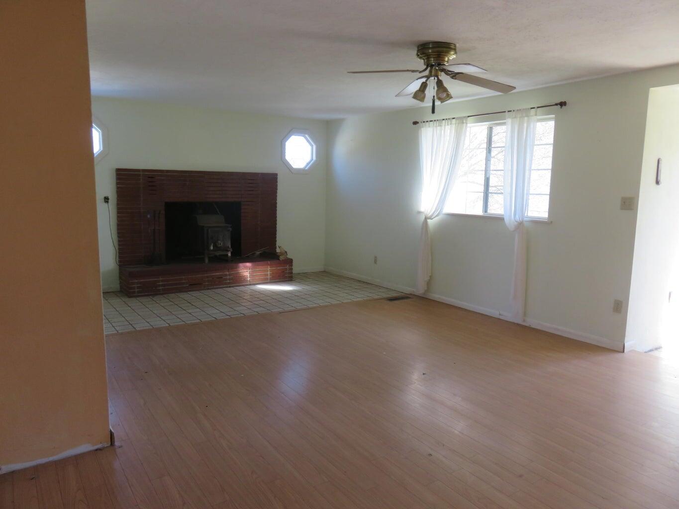 295 County Road 149 Lookout, CA 96054 - Photo 21 of 40 an empty room with windows and fireplace