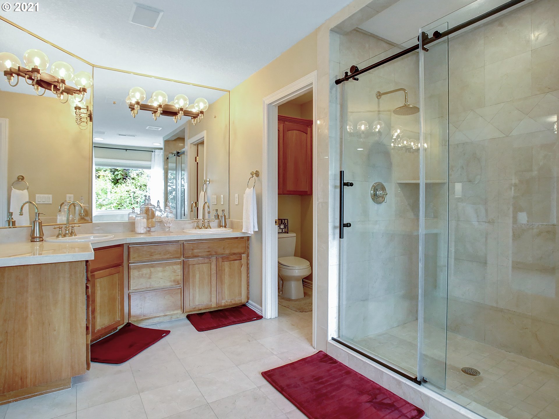8316 Northwest Ridgetop Court Portland, OR 97229 - Photo 17 of 32 a bathroom with a granite countertop sink a mirror a bathtub and shower