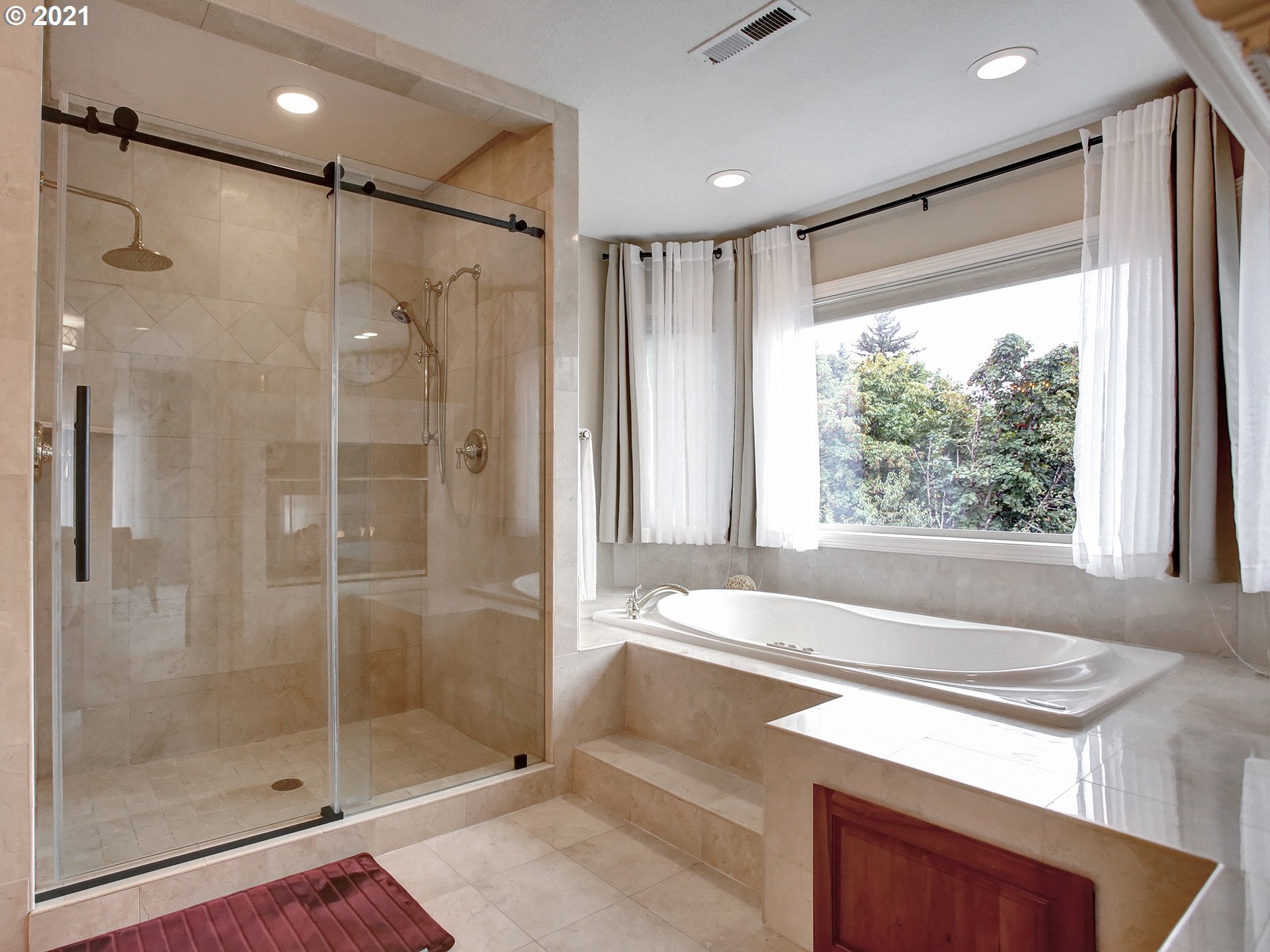 8316 Northwest Ridgetop Court Portland, OR 97229 - Photo 19 of 32 a bathroom with a bathtub and a shower