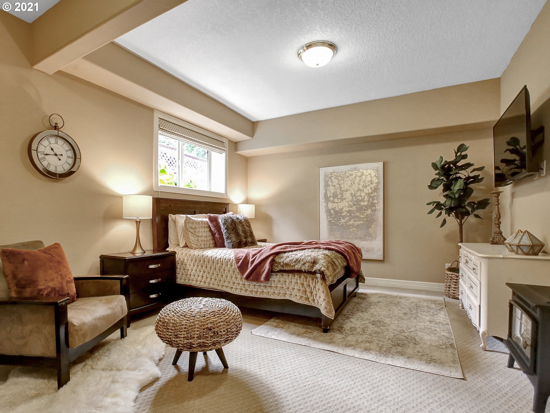 8316 Northwest Ridgetop Court Portland, OR 97229 - Photo 25 of 32 a bedroom with a bed and a chandelier
