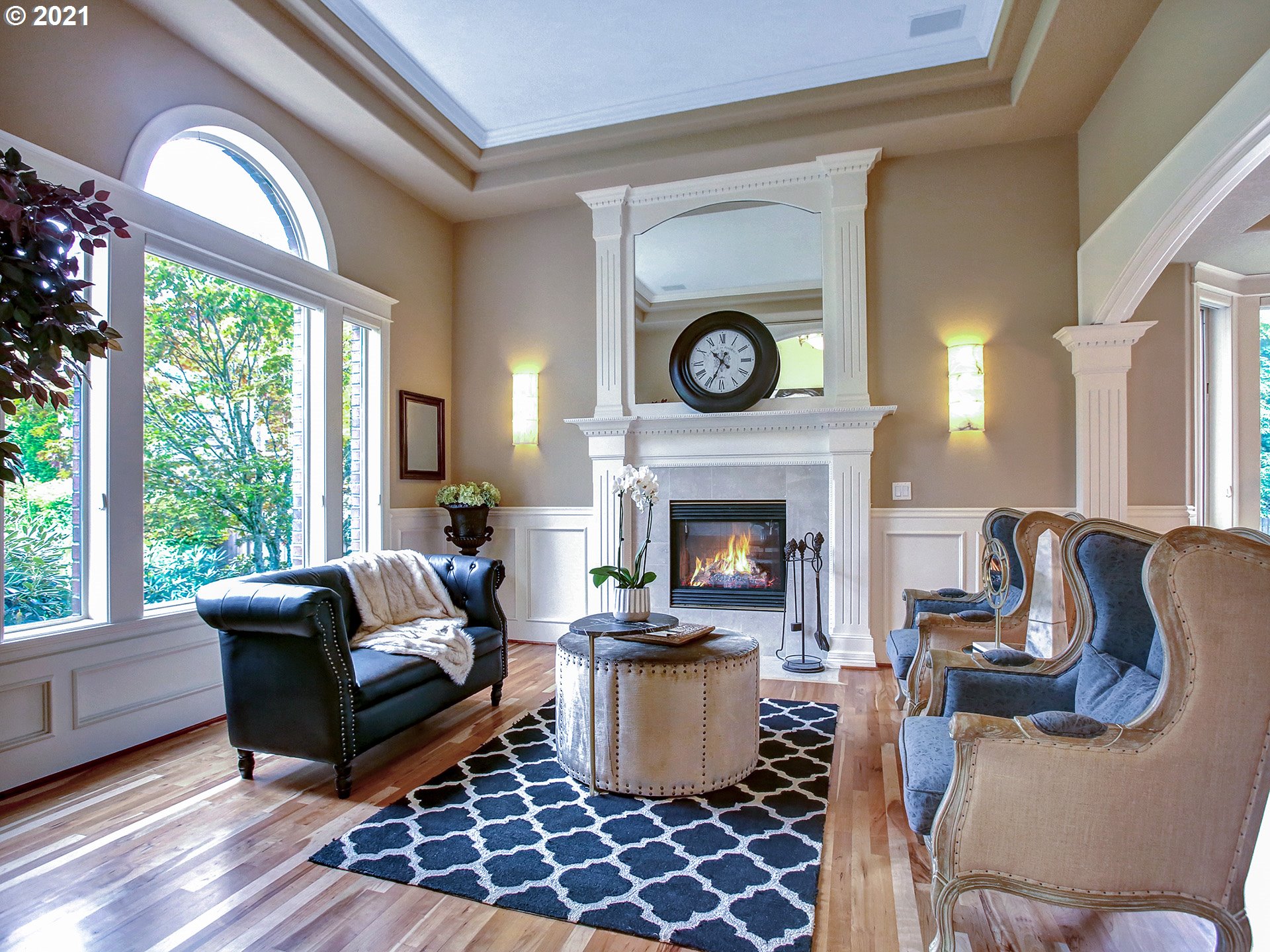 8316 Northwest Ridgetop Court Portland, OR 97229 - Photo 4 of 32 a living room with furniture a clock and a fireplace