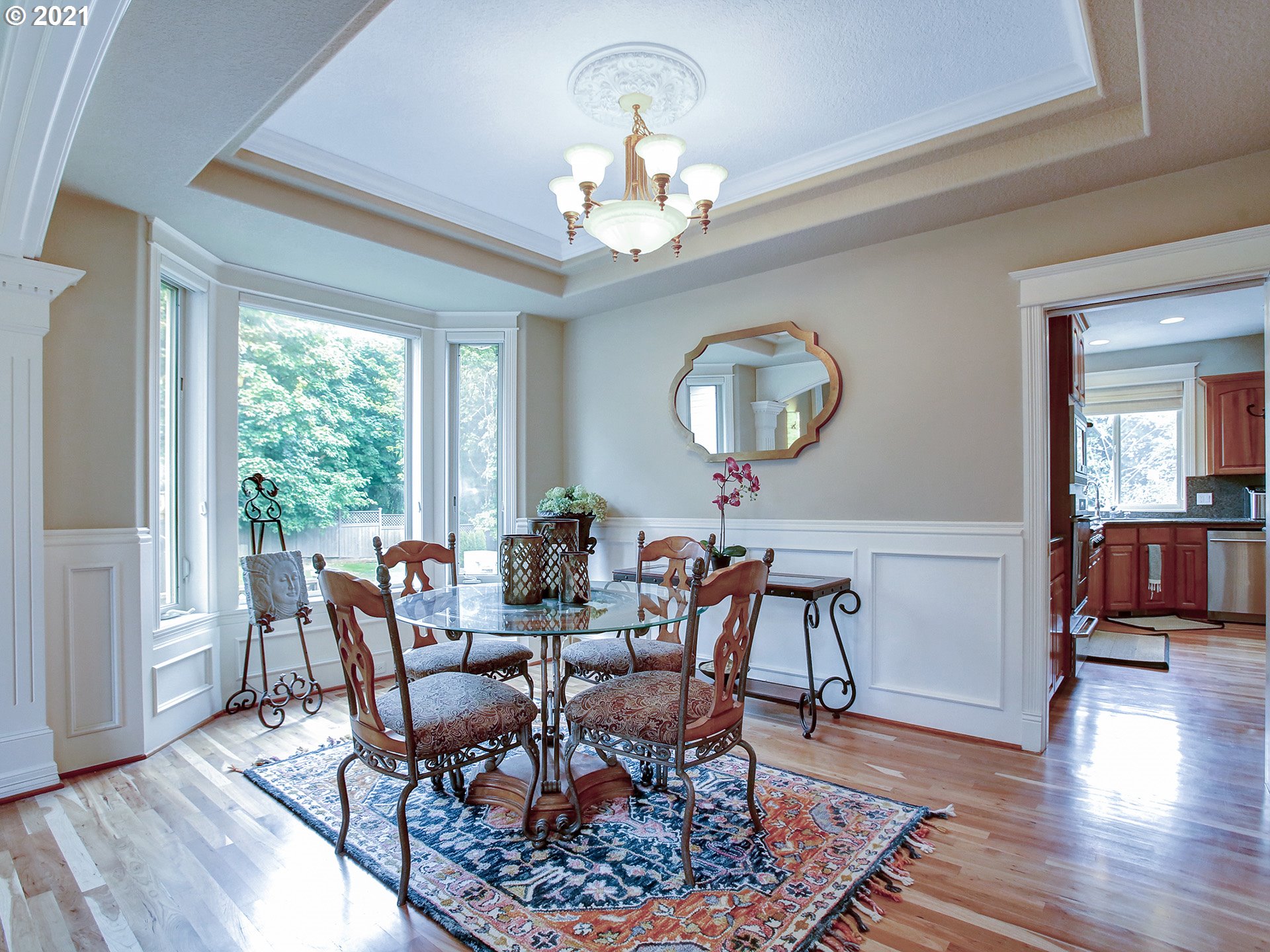 8316 Northwest Ridgetop Court Portland, OR 97229 - Photo 6 of 32 a view of a dining room with furniture a chandelier and wooden floor