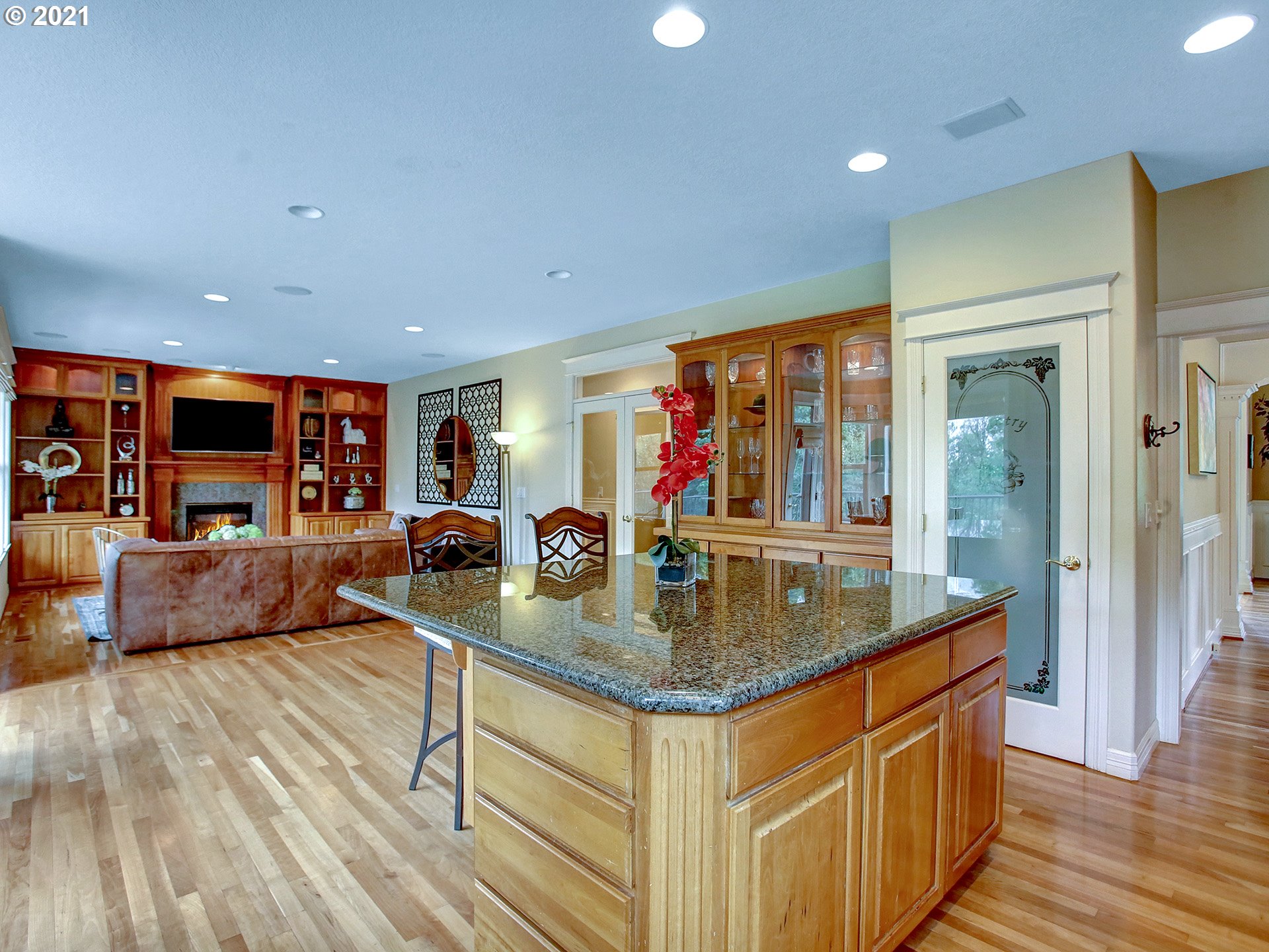 8316 Northwest Ridgetop Court Portland, OR 97229 - Photo 9 of 32 a view of kitchen island wooden floor center island stainless steel appliances and living room view