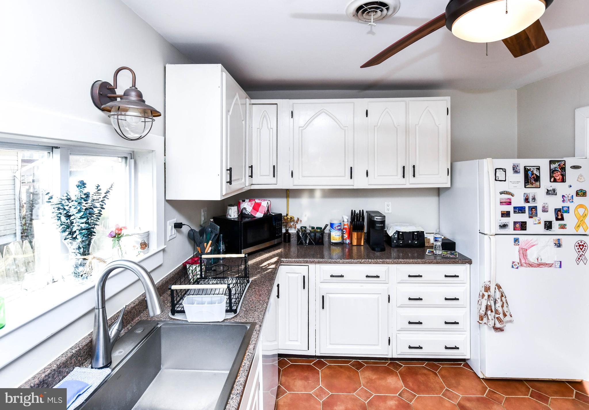 823 Selby Boulevard Edgewater, MD 21037 - Photo 18 of 40 a kitchen with white cabinets and appliances