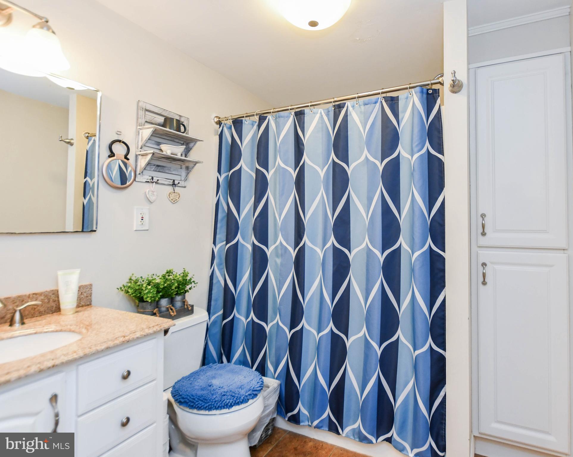 823 Selby Boulevard Edgewater, MD 21037 - Photo 23 of 40 a bathroom with a granite countertop sink and a mirror