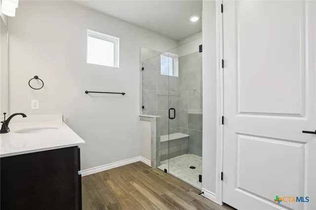 a bathroom with a sink and a mirror with bathtub