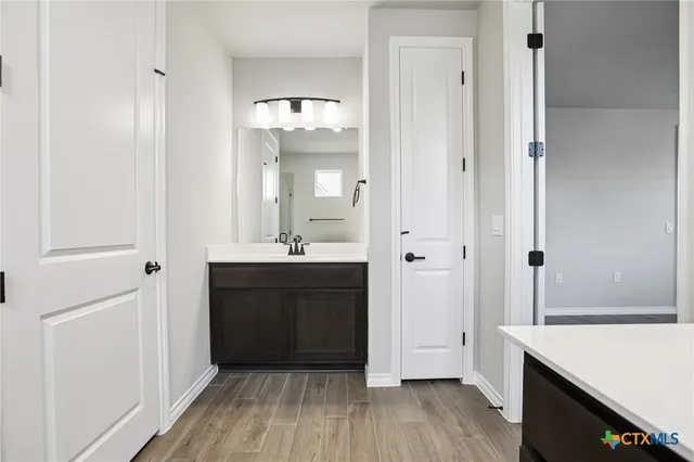 a spacious bathroom with a sink and a mirror