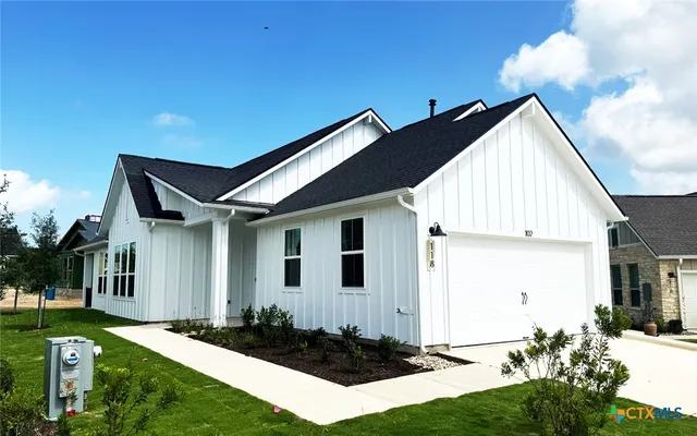 a view of backyard of house with green space