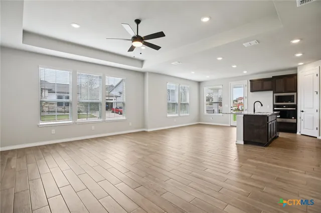 a view of kitchen with furniture and wooden floor