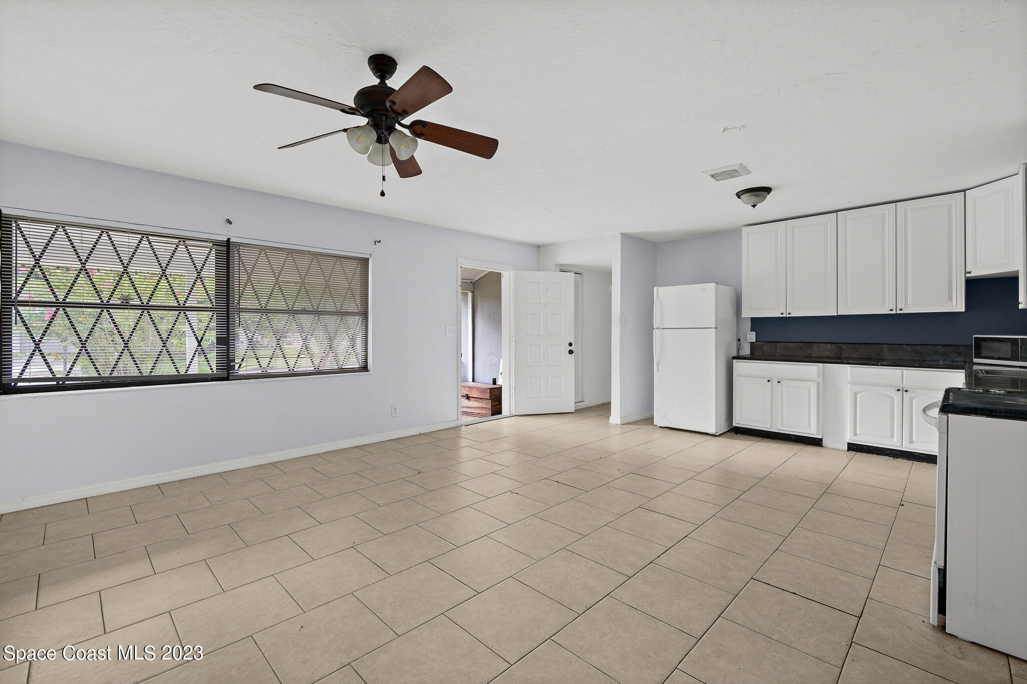 265 Lee Road Melbourne, FL 32904 - Photo 2 of 10 a view of a kitchen with microwave and windows