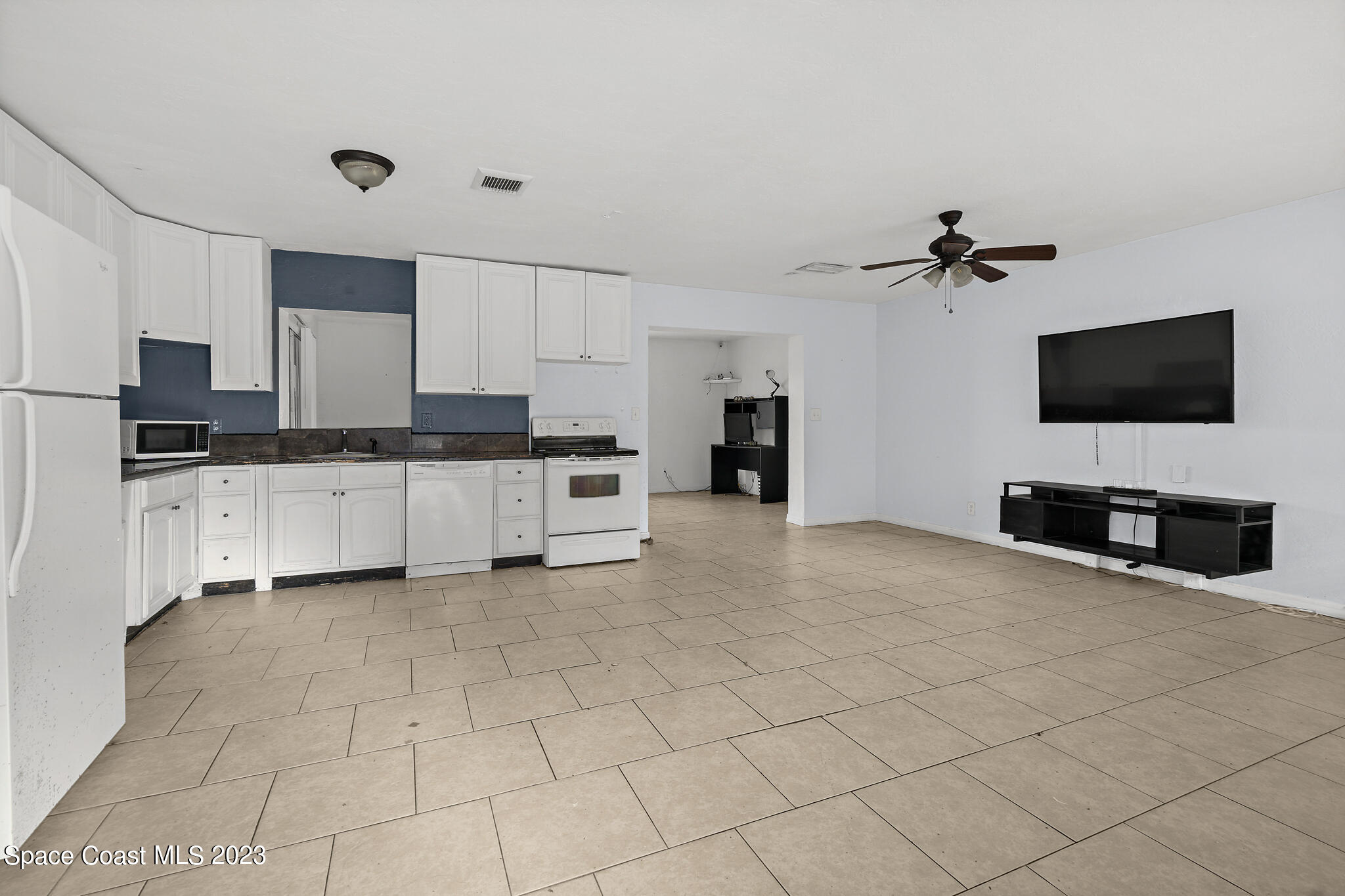 265 Lee Road Melbourne, FL 32904 - Photo 3 of 10 a kitchen with stainless steel appliances a stove a sink and a refrigerator