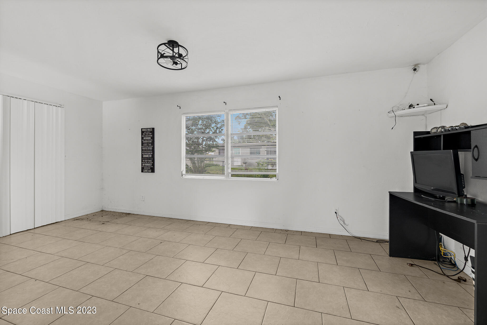 265 Lee Road Melbourne, FL 32904 - Photo 4 of 10 a view of a livingroom with an empty space and a window