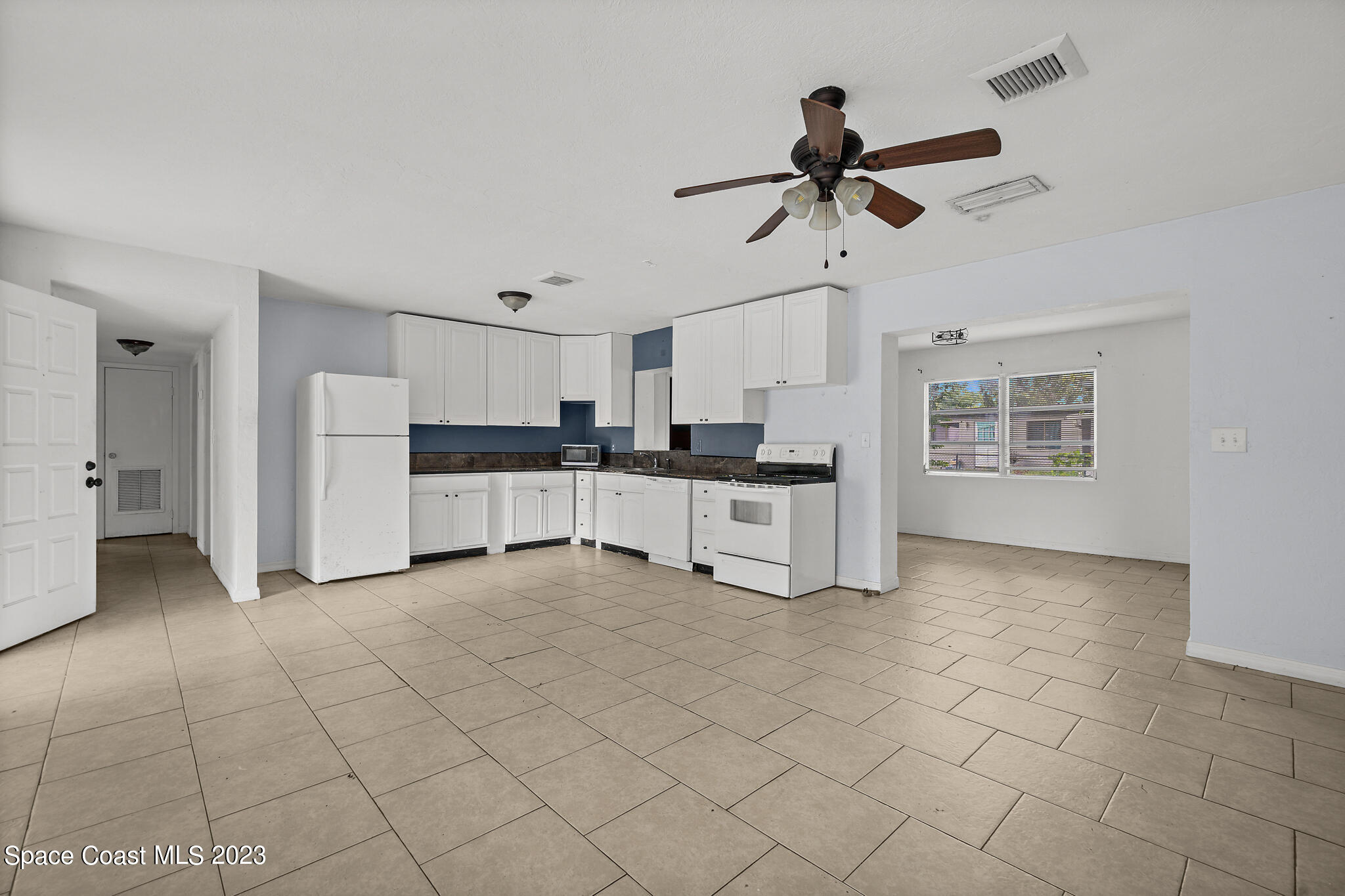 265 Lee Road Melbourne, FL 32904 - Photo 5 of 10 a view of kitchen with white cabinets and window