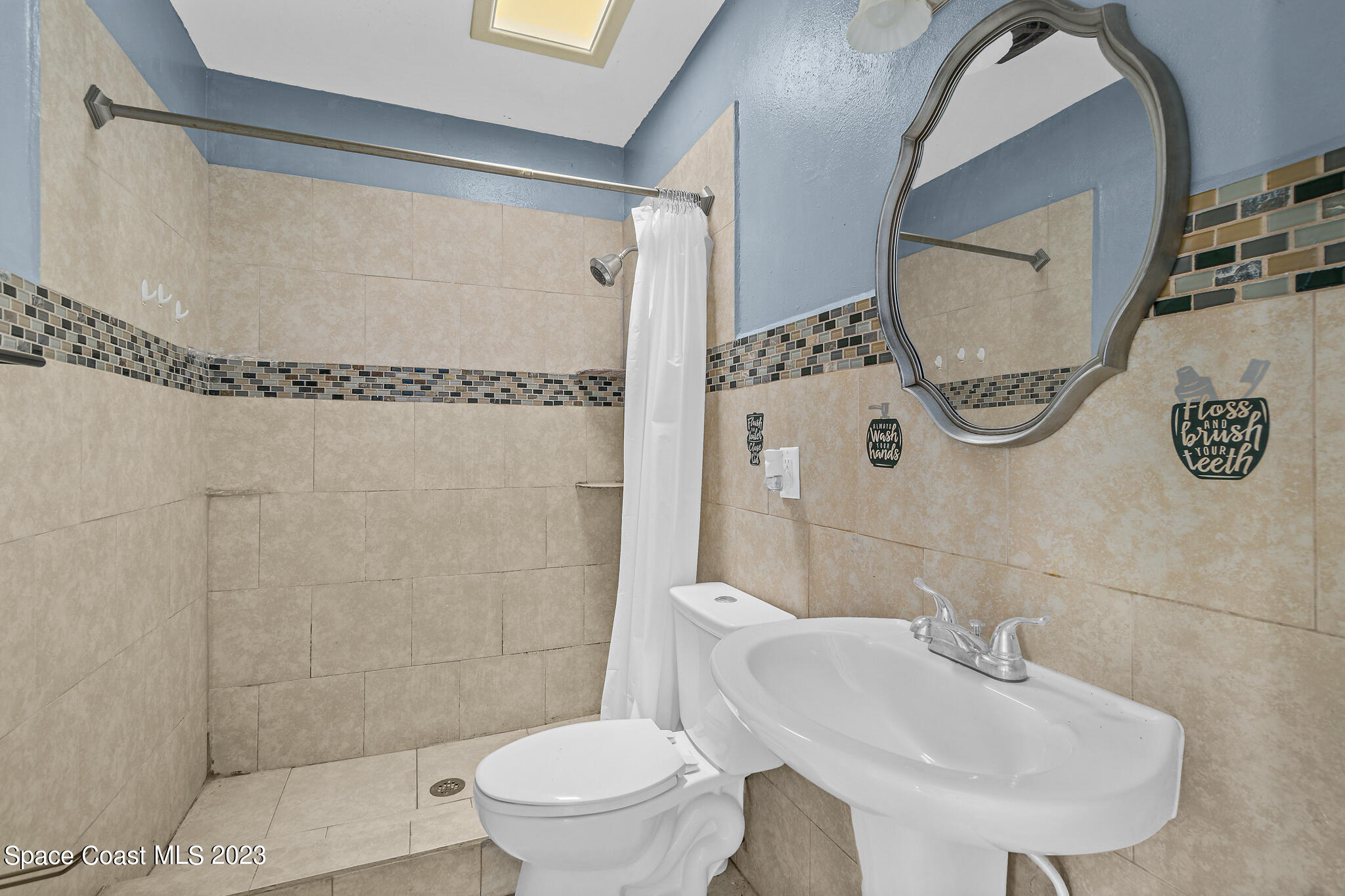 265 Lee Road Melbourne, FL 32904 - Photo 6 of 10 a bathroom with a sink toilet and shower