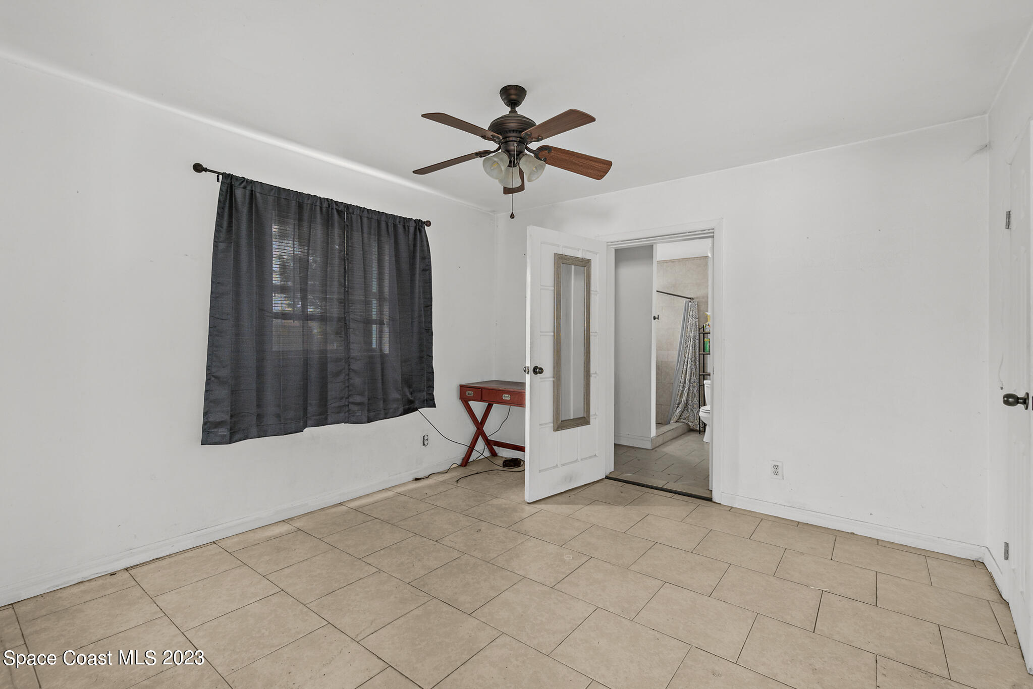 265 Lee Road Melbourne, FL 32904 - Photo 7 of 10 a living room with a window and a ceiling fan