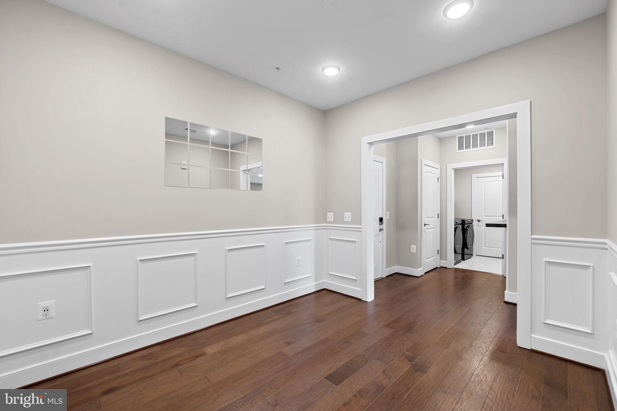 210 Decoverly Drive, Unit 106 Gaithersburg, MD 20878 - Photo 11 of 59 a view of an empty room with wooden floor