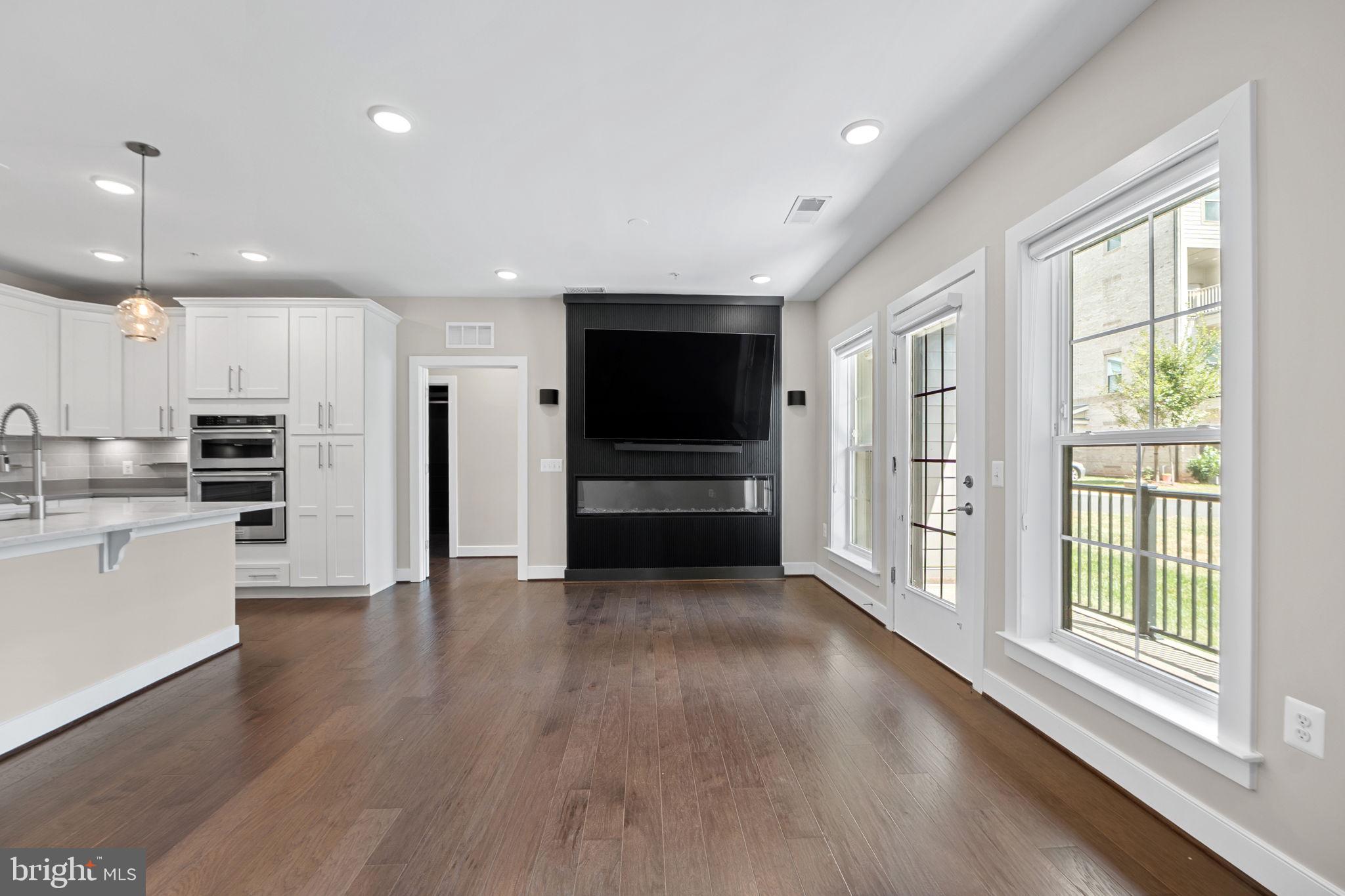 210 Decoverly Drive, Unit 106 Gaithersburg, MD 20878 - Photo 17 of 59 a view of kitchen with wooden floor and electronic appliances