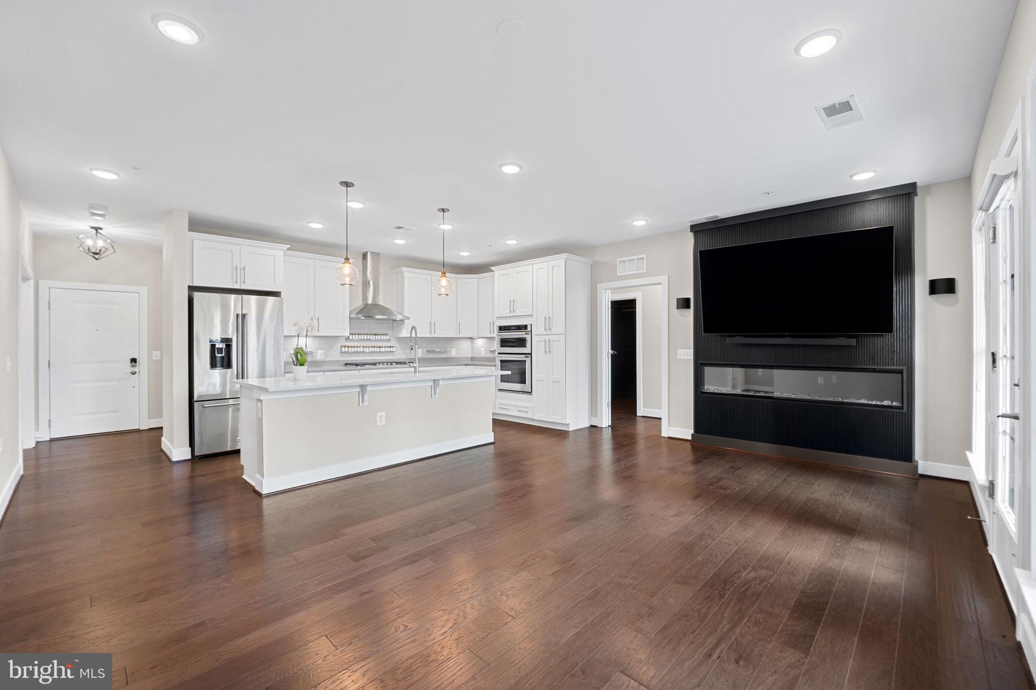 210 Decoverly Drive, Unit 106 Gaithersburg, MD 20878 - Photo 19 of 59 a view of kitchen with refrigerator stove microwave and cabinets