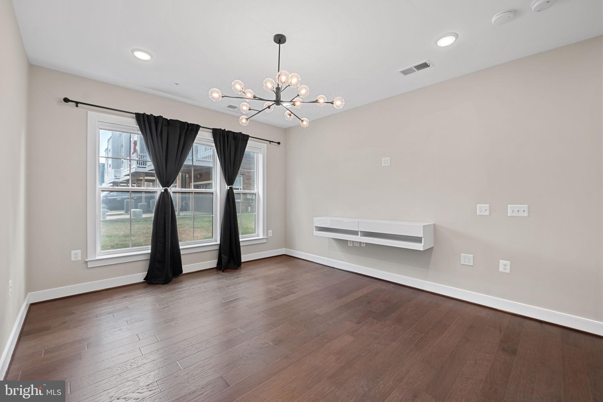 210 Decoverly Drive, Unit 106 Gaithersburg, MD 20878 - Photo 24 of 59 a view of a livingroom with a ceiling fan and window