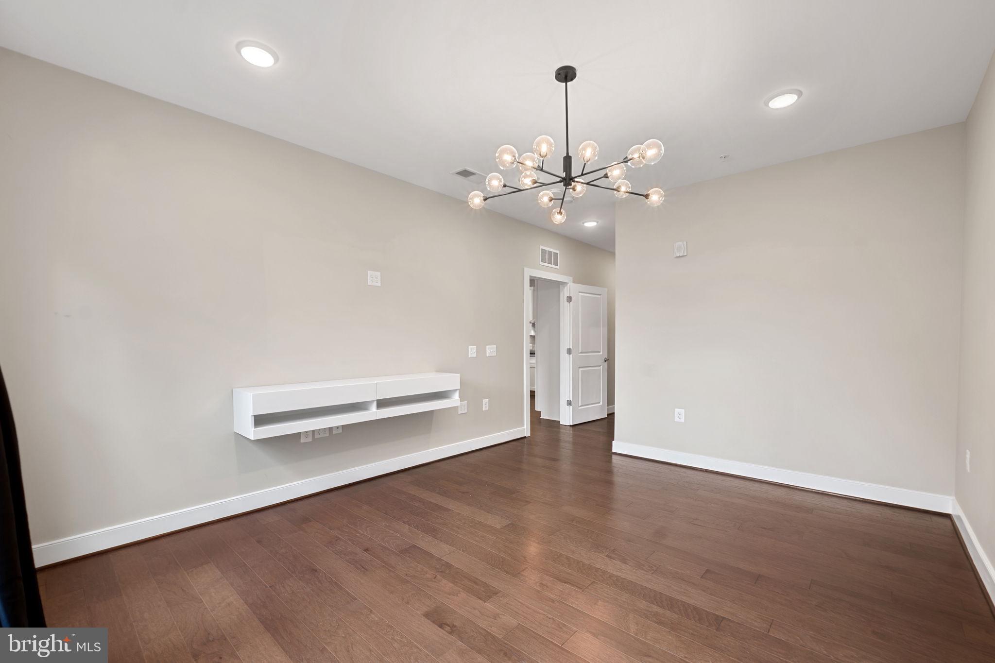 210 Decoverly Drive, Unit 106 Gaithersburg, MD 20878 - Photo 26 of 59 wooden floor in an empty room with a window