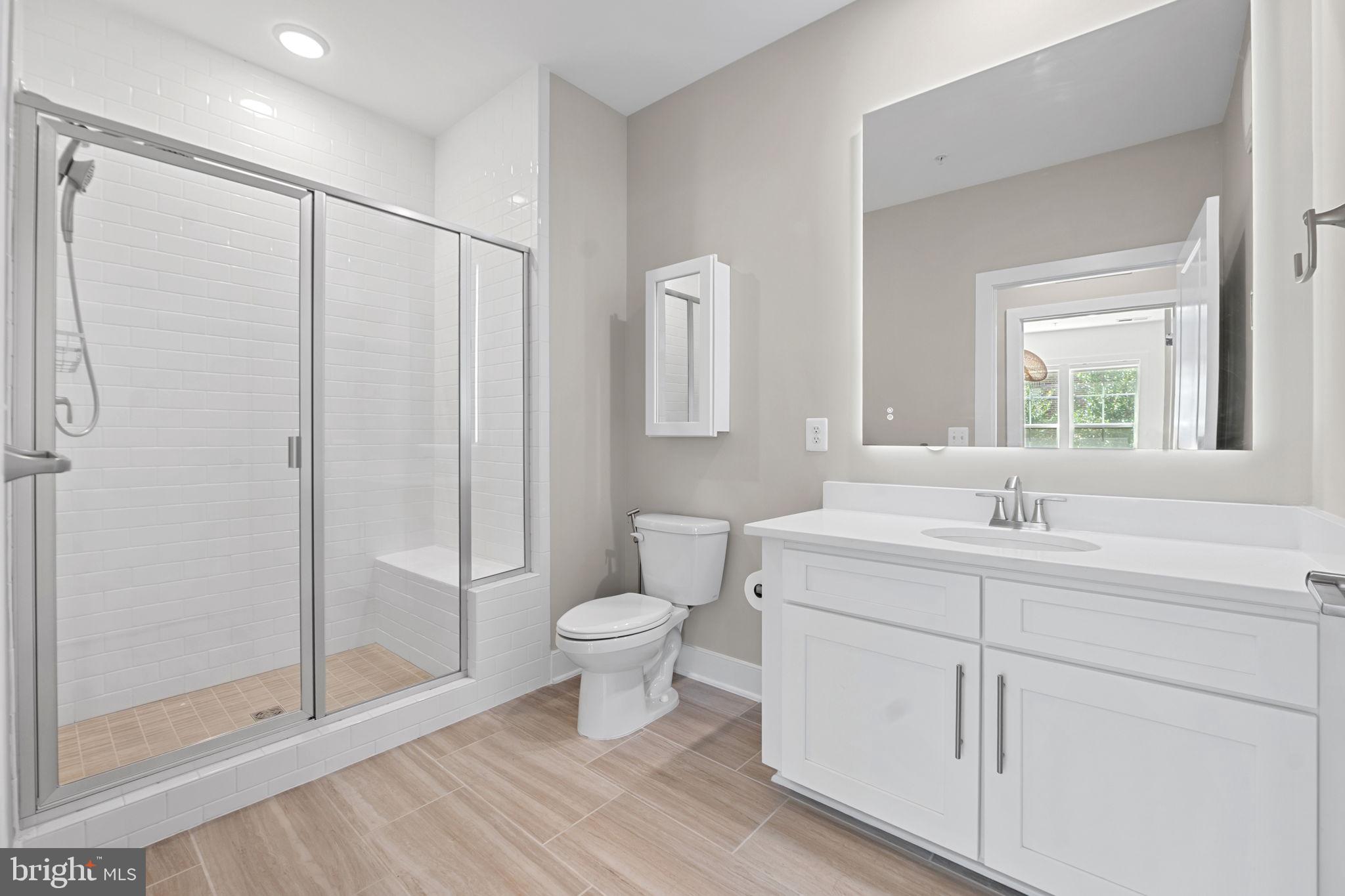 210 Decoverly Drive, Unit 106 Gaithersburg, MD 20878 - Photo 31 of 59 a bathroom with a sink toilet a mirror and shower