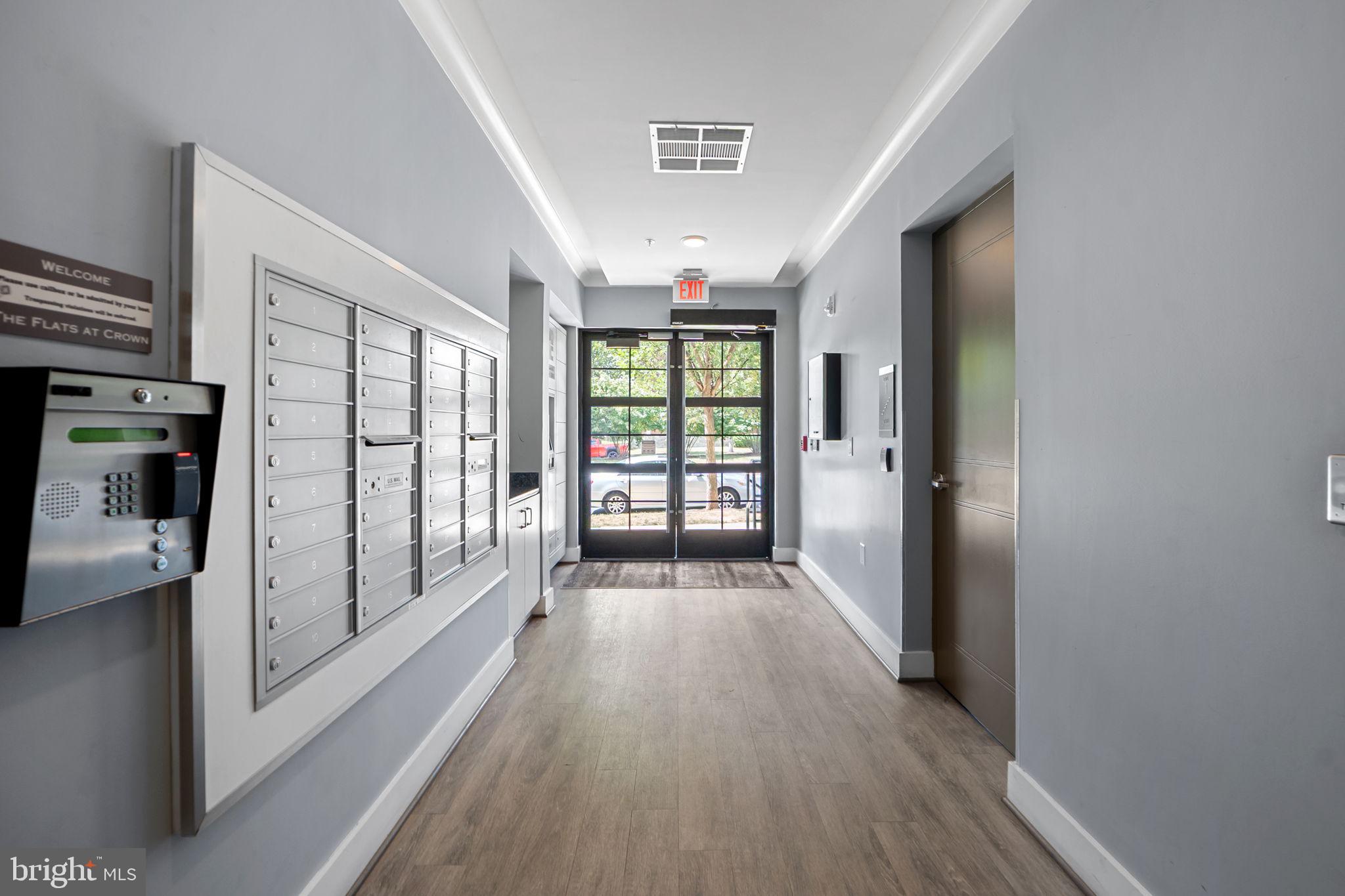210 Decoverly Drive, Unit 106 Gaithersburg, MD 20878 - Photo 33 of 59 a view of a hallway with wooden floor and windows