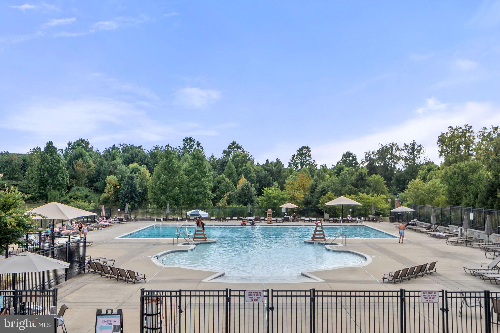 210 Decoverly Drive, Unit 106 Gaithersburg, MD 20878 - Photo 35 of 59 a view of a swimming pool with a patio