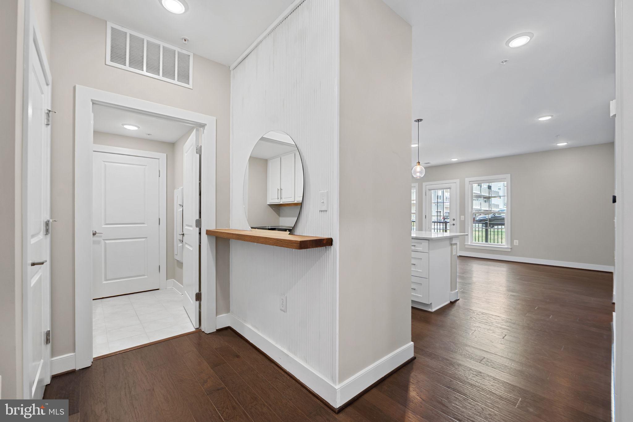 210 Decoverly Drive, Unit 106 Gaithersburg, MD 20878 - Photo 5 of 59 wooden floor in an empty room with a window