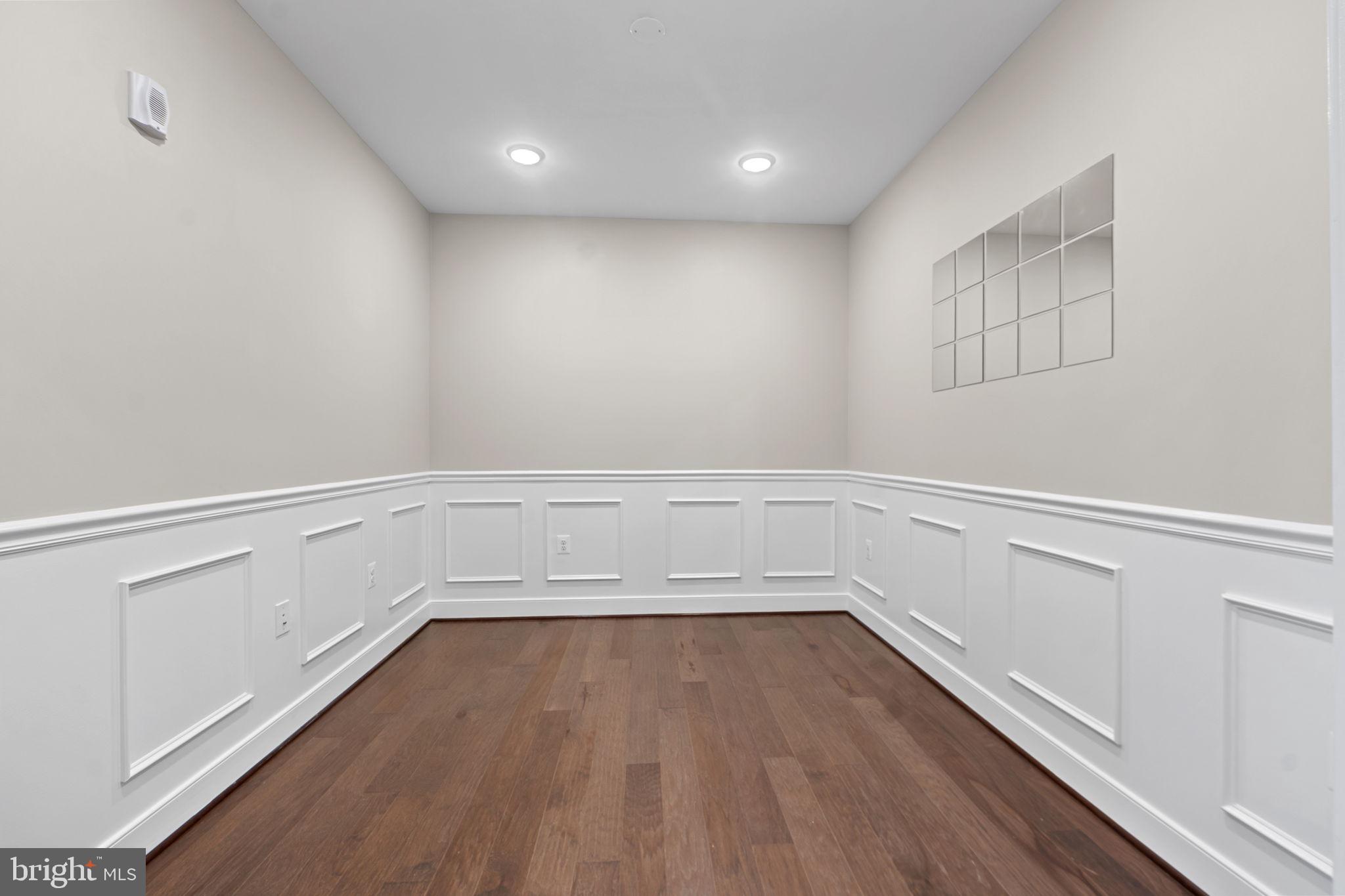 210 Decoverly Drive, Unit 106 Gaithersburg, MD 20878 - Photo 7 of 59 a view of an empty room with wooden floor