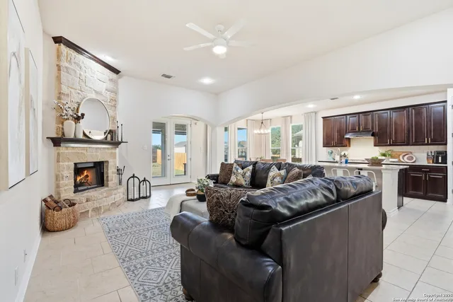 a living room with furniture and a kitchen area