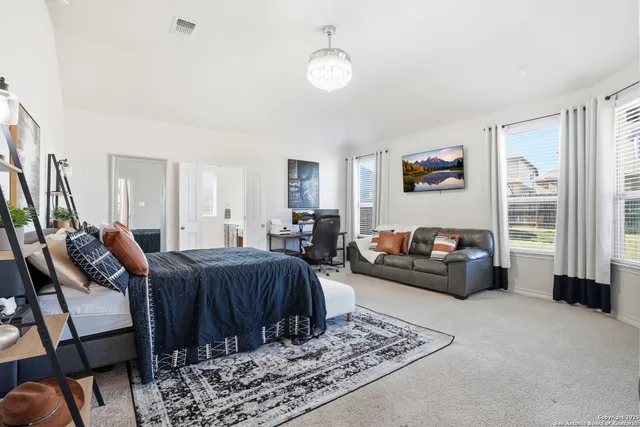 a spacious bathroom with a granite countertop double vanity sink and a mirror