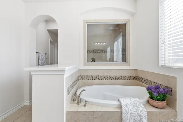 a bathroom with a double vanity sink toilet and mirror