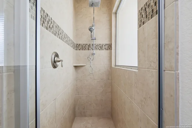 a bedroom with a bed with window