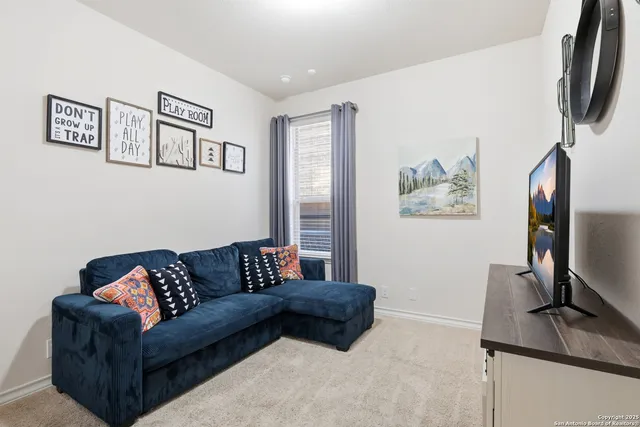 a view of a workspace with furniture and a window