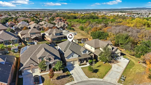 an aerial view of residential houses with outdoor space