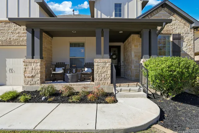 a view of a house with potted plants