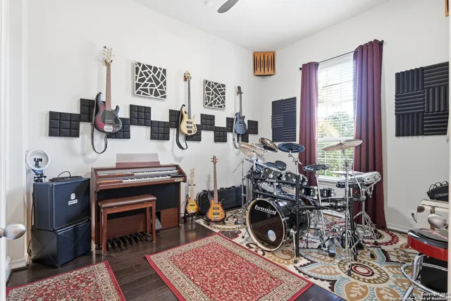 a living room with furniture and a piano