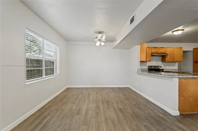 a view of a kitchen with a sink wooden floor and a window