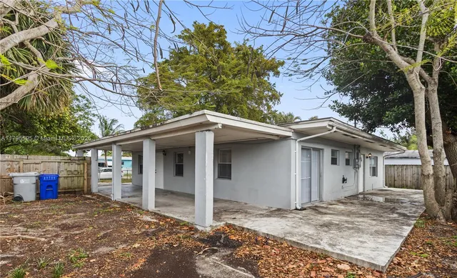 a view of a house with a tree in front of it