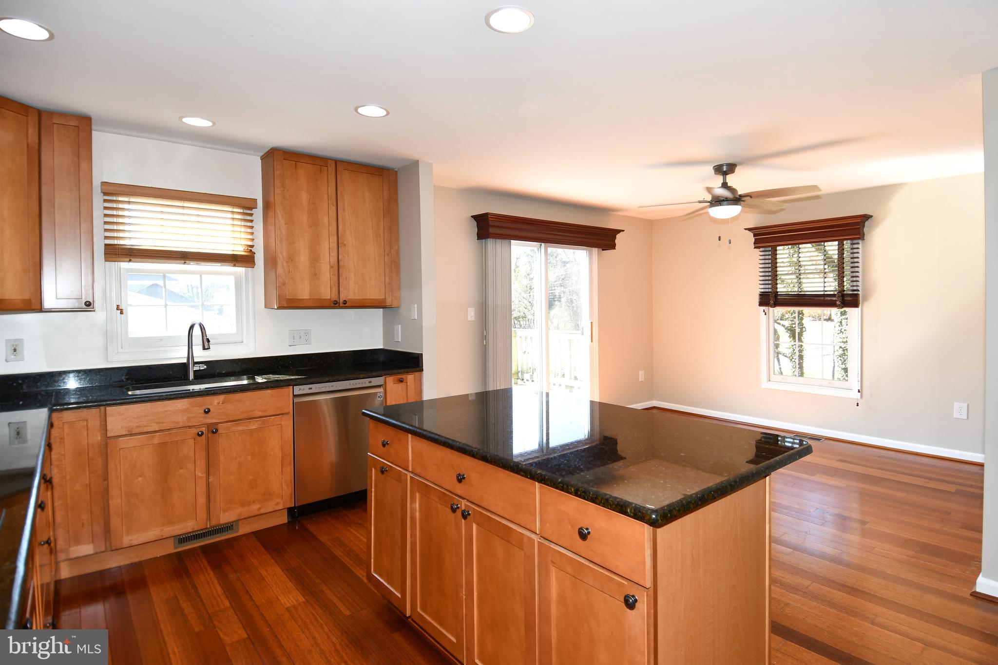 1048 Windrush Lane, Unit 39 Sandy Spring, MD 20860 - Photo 12 of 39 a kitchen with granite countertop a sink cabinets and wooden floor