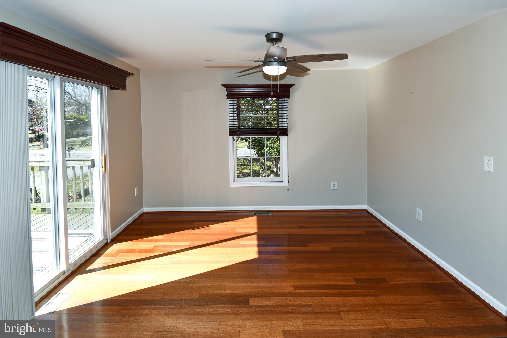 1048 Windrush Lane, Unit 39 Sandy Spring, MD 20860 - Photo 15 of 39 a view of an empty room with wooden floor and a window