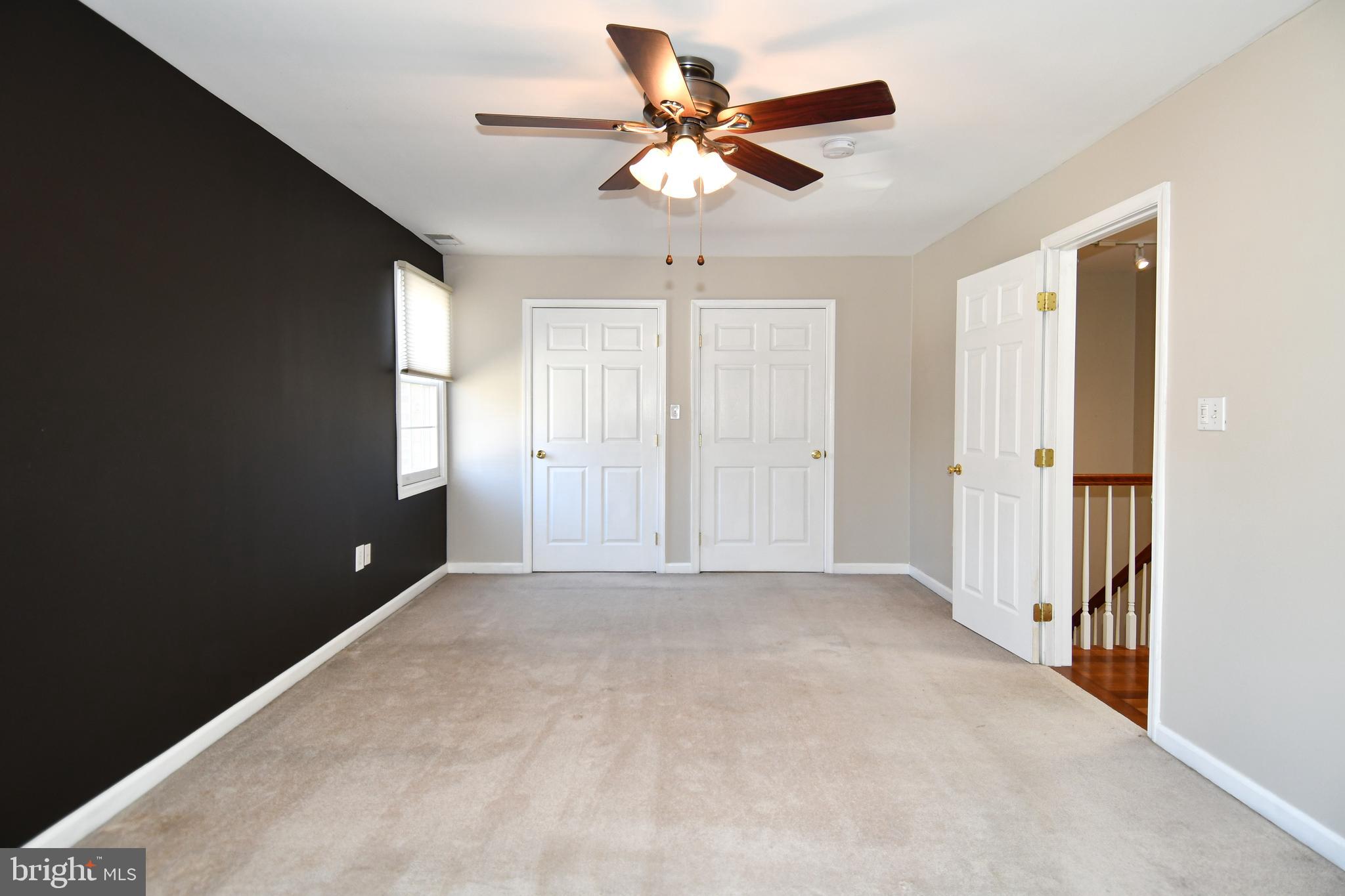 1048 Windrush Lane, Unit 39 Sandy Spring, MD 20860 - Photo 18 of 39 an empty room with windows and fan