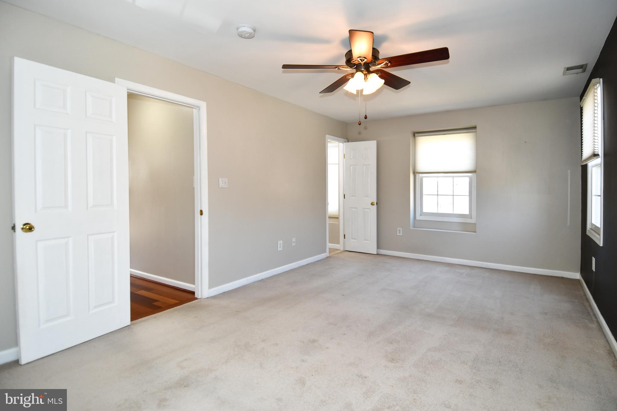 1048 Windrush Lane, Unit 39 Sandy Spring, MD 20860 - Photo 20 of 39 a view of a livingroom with a ceiling fan and window