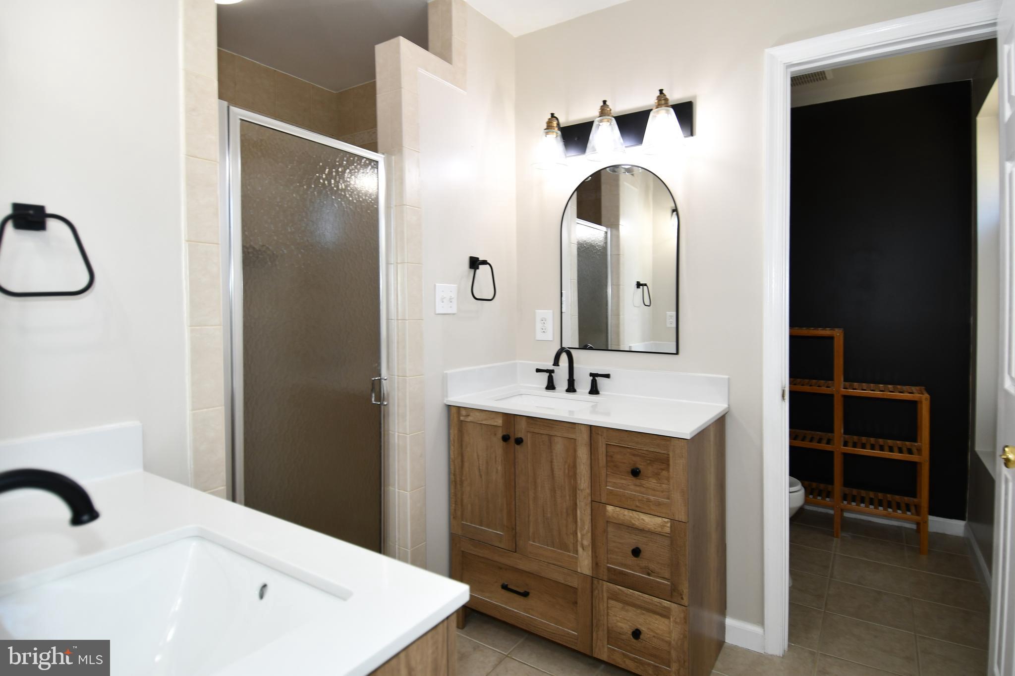 1048 Windrush Lane, Unit 39 Sandy Spring, MD 20860 - Photo 21 of 39 a bathroom with a sink and a mirror