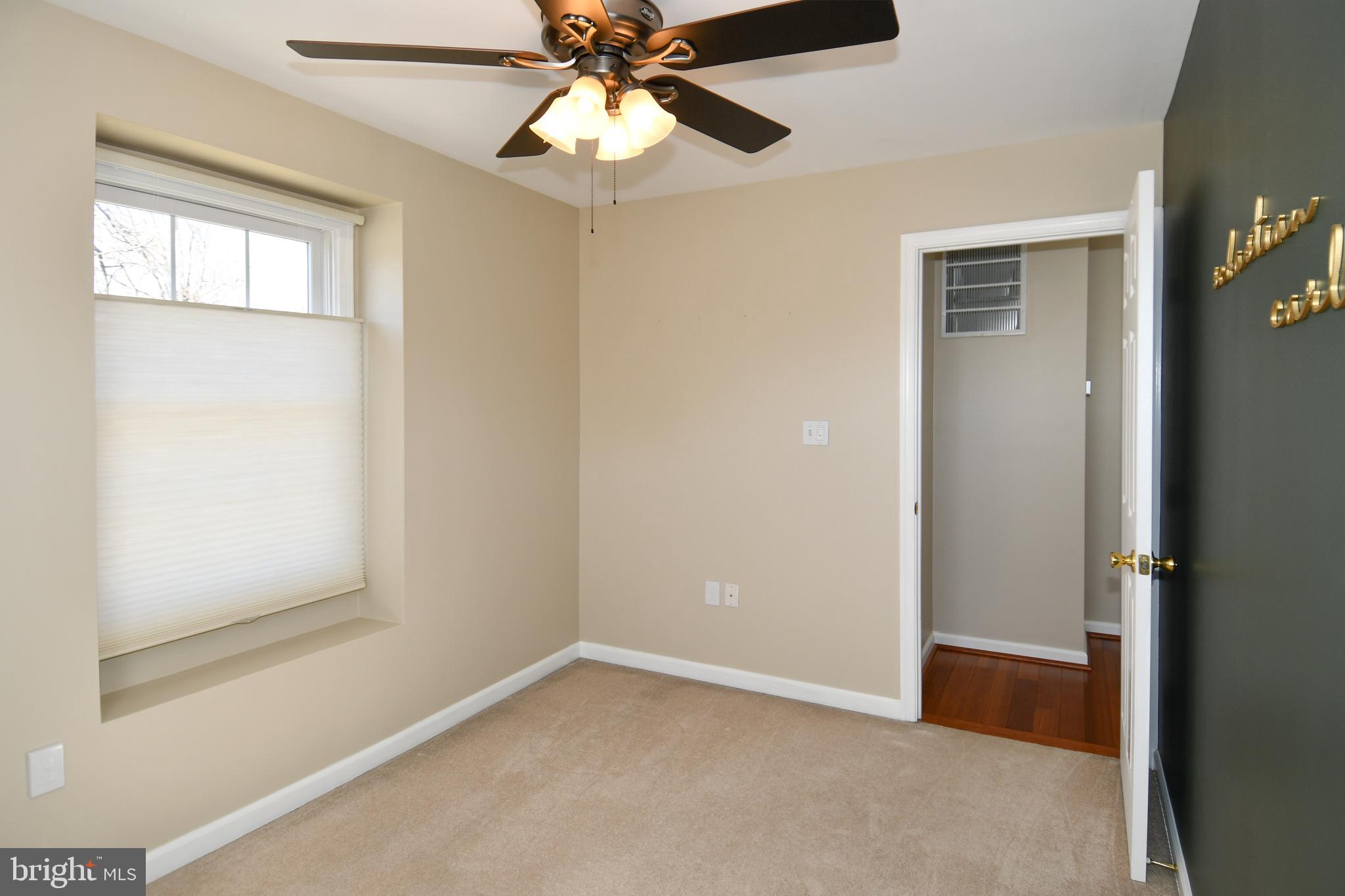 1048 Windrush Lane, Unit 39 Sandy Spring, MD 20860 - Photo 25 of 39 an empty room with windows and fan