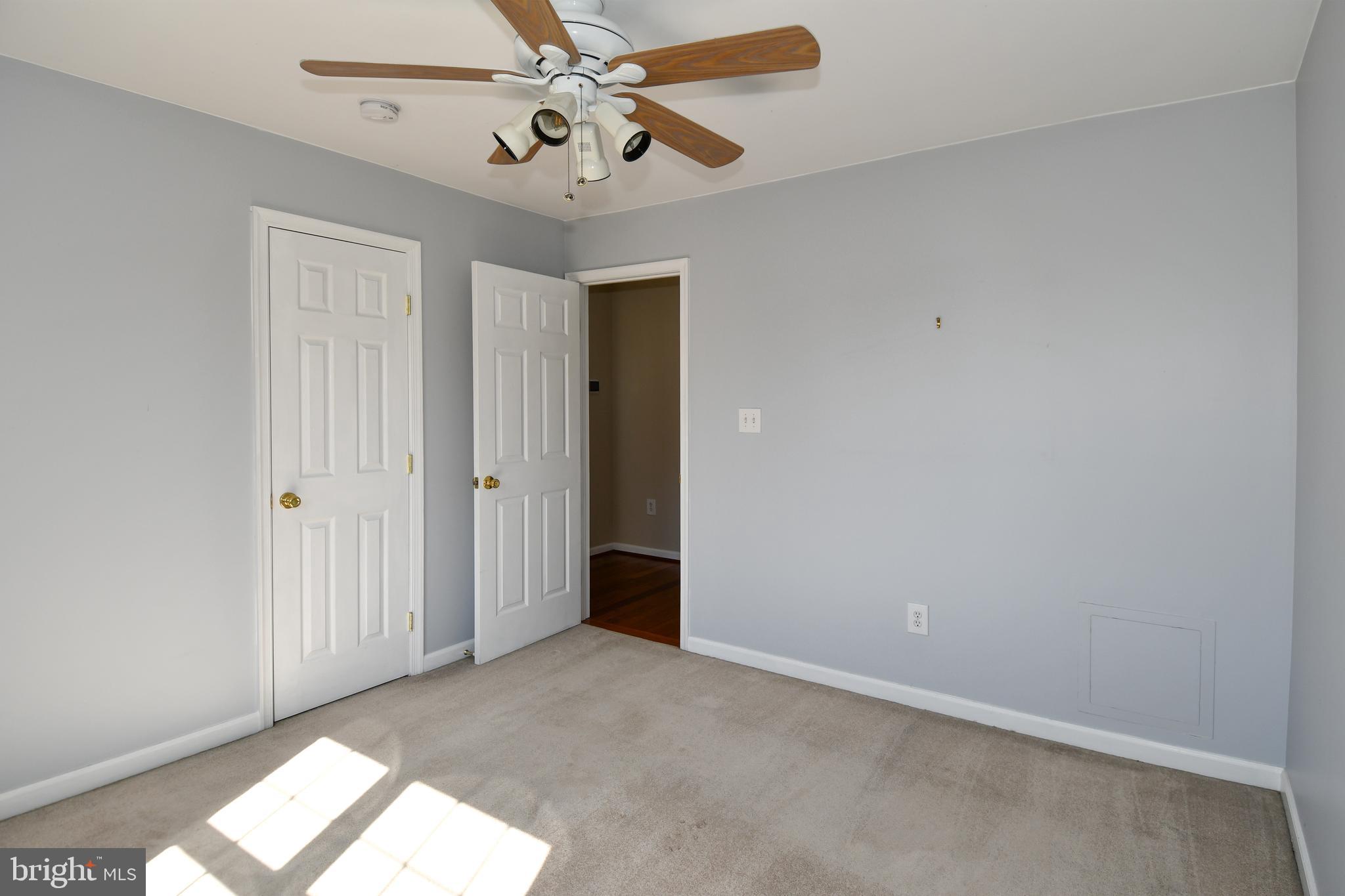 1048 Windrush Lane, Unit 39 Sandy Spring, MD 20860 - Photo 27 of 39 an empty room with windows and fan