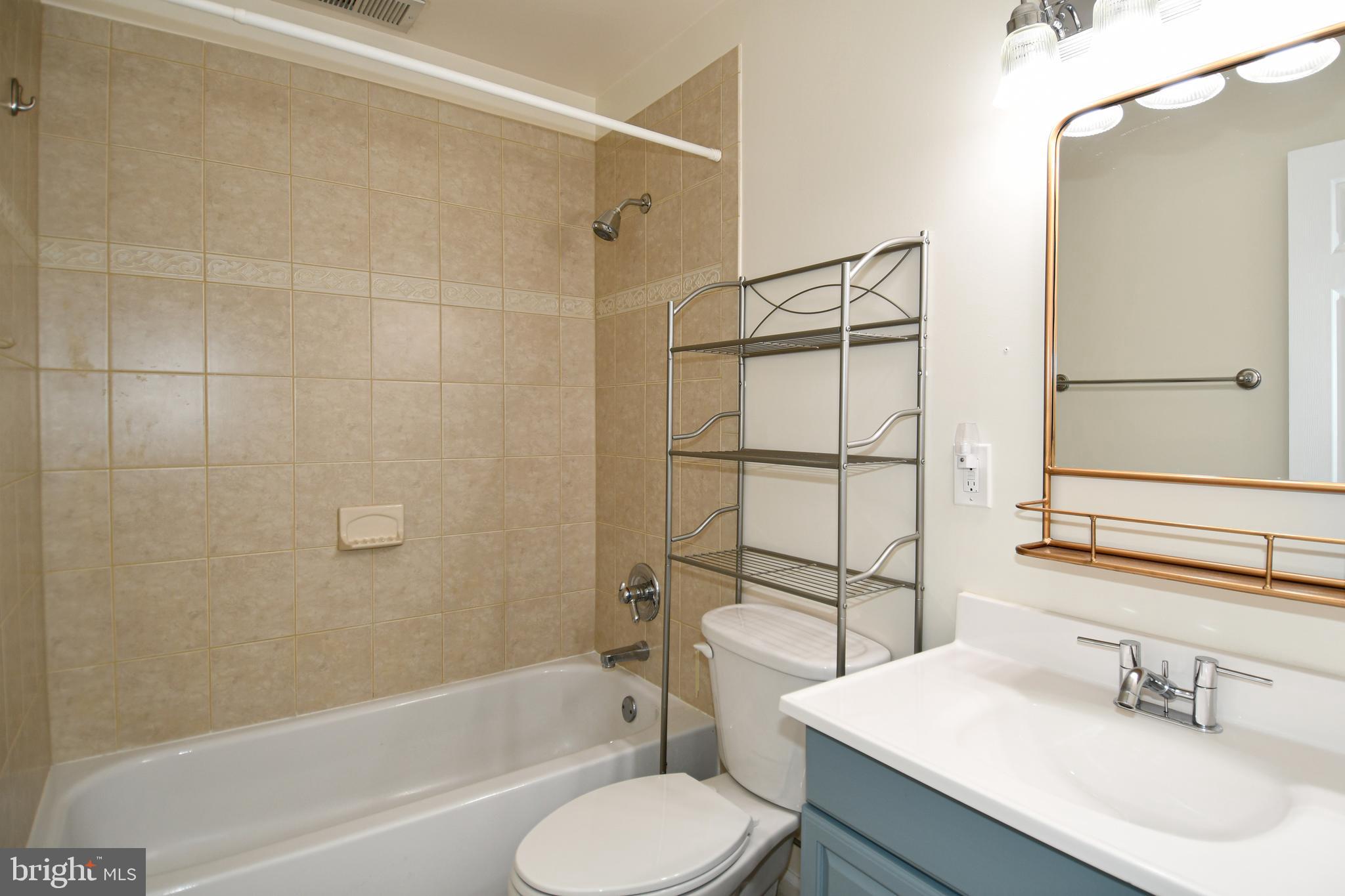1048 Windrush Lane, Unit 39 Sandy Spring, MD 20860 - Photo 28 of 39 a bathroom with a sink toilet and shower