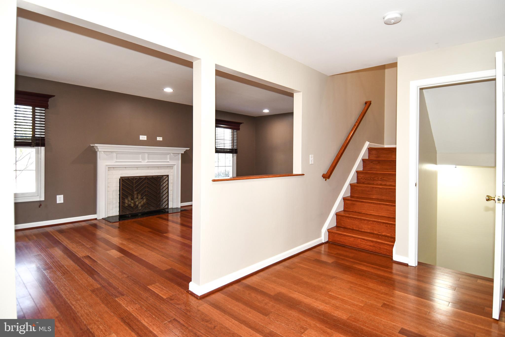 1048 Windrush Lane, Unit 39 Sandy Spring, MD 20860 - Photo 3 of 39 a view of a livingroom with wooden floor and a fireplace