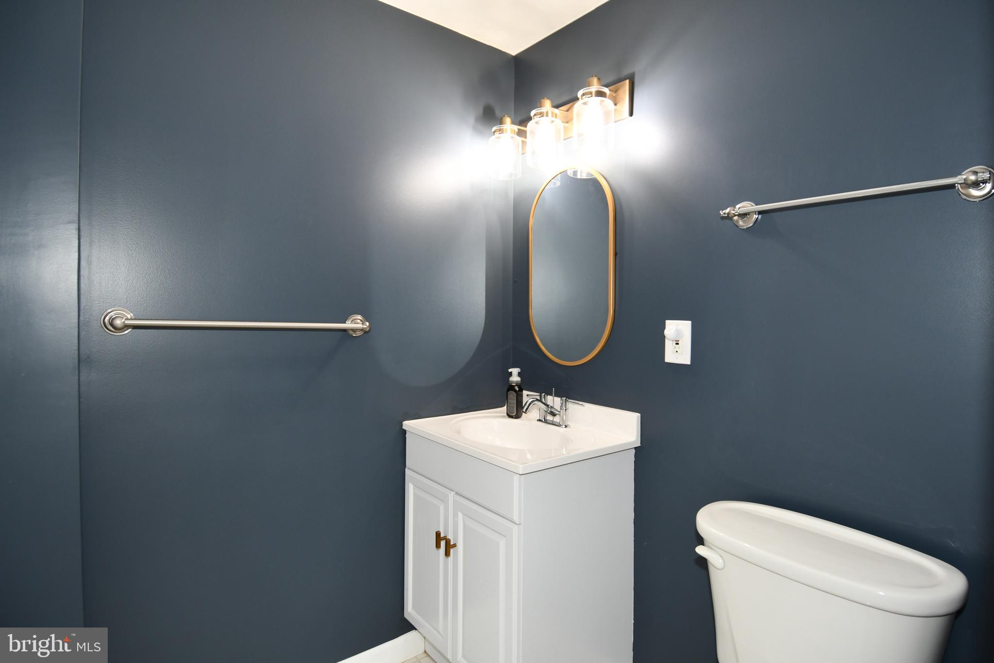 1048 Windrush Lane, Unit 39 Sandy Spring, MD 20860 - Photo 32 of 39 a bathroom with a toilet sink and mirror