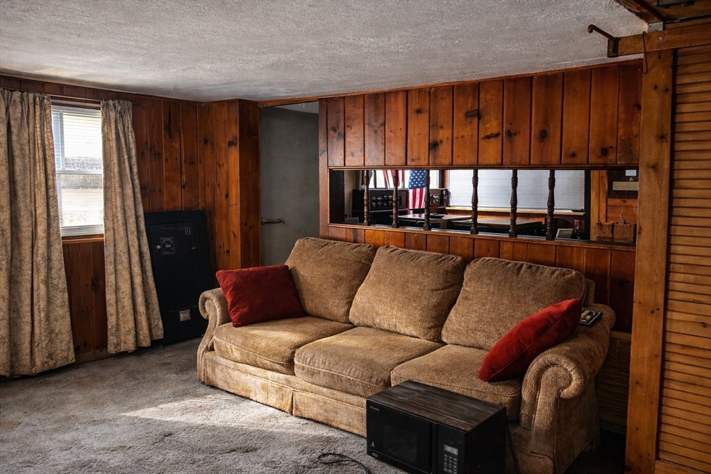 43 Trinity Avenue Sterling, MA 01564 - Photo 17 of 18 a living room with furniture a window and a flat screen tv